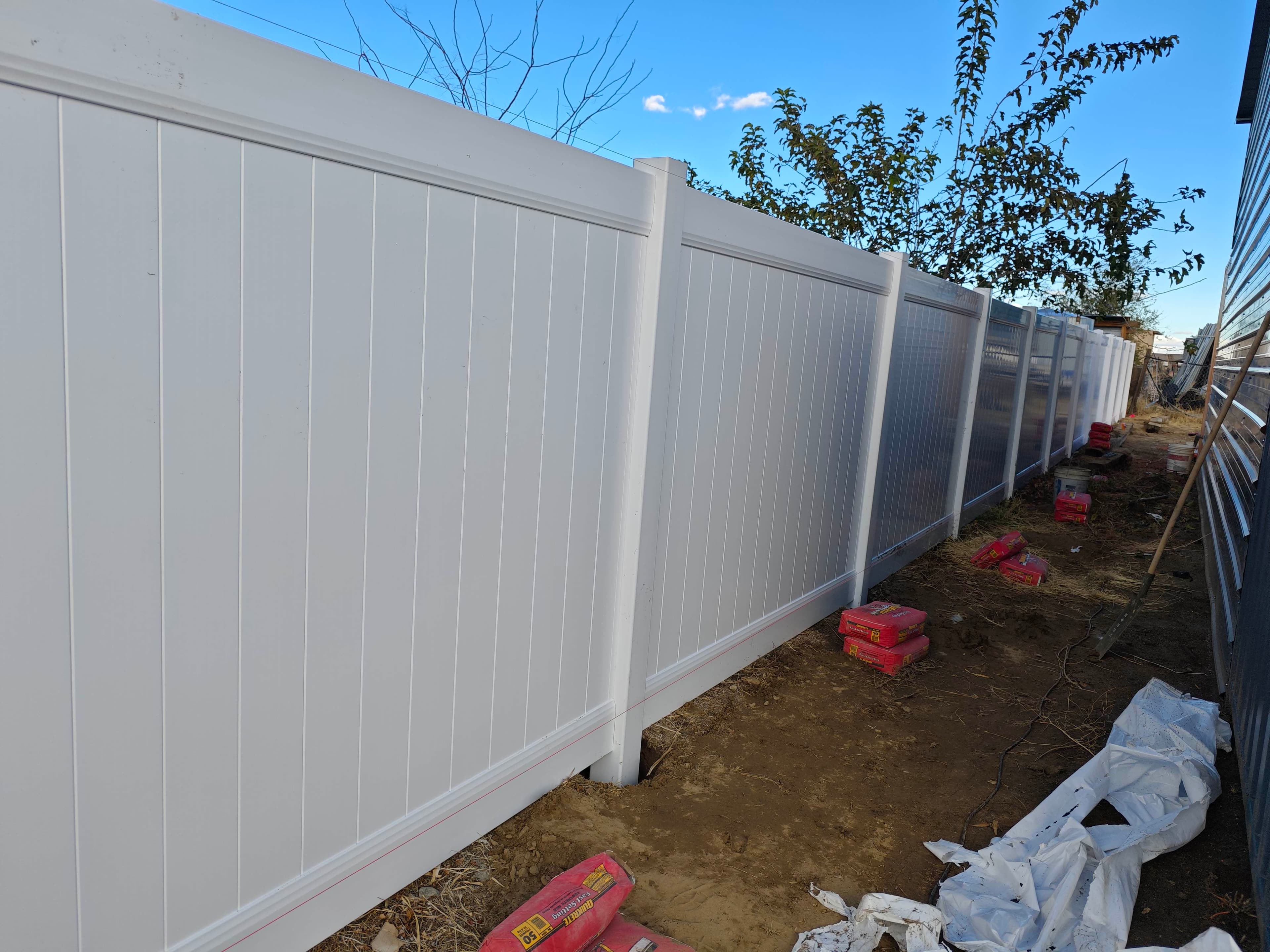 Finish detail on a white vinyl privacy fence
