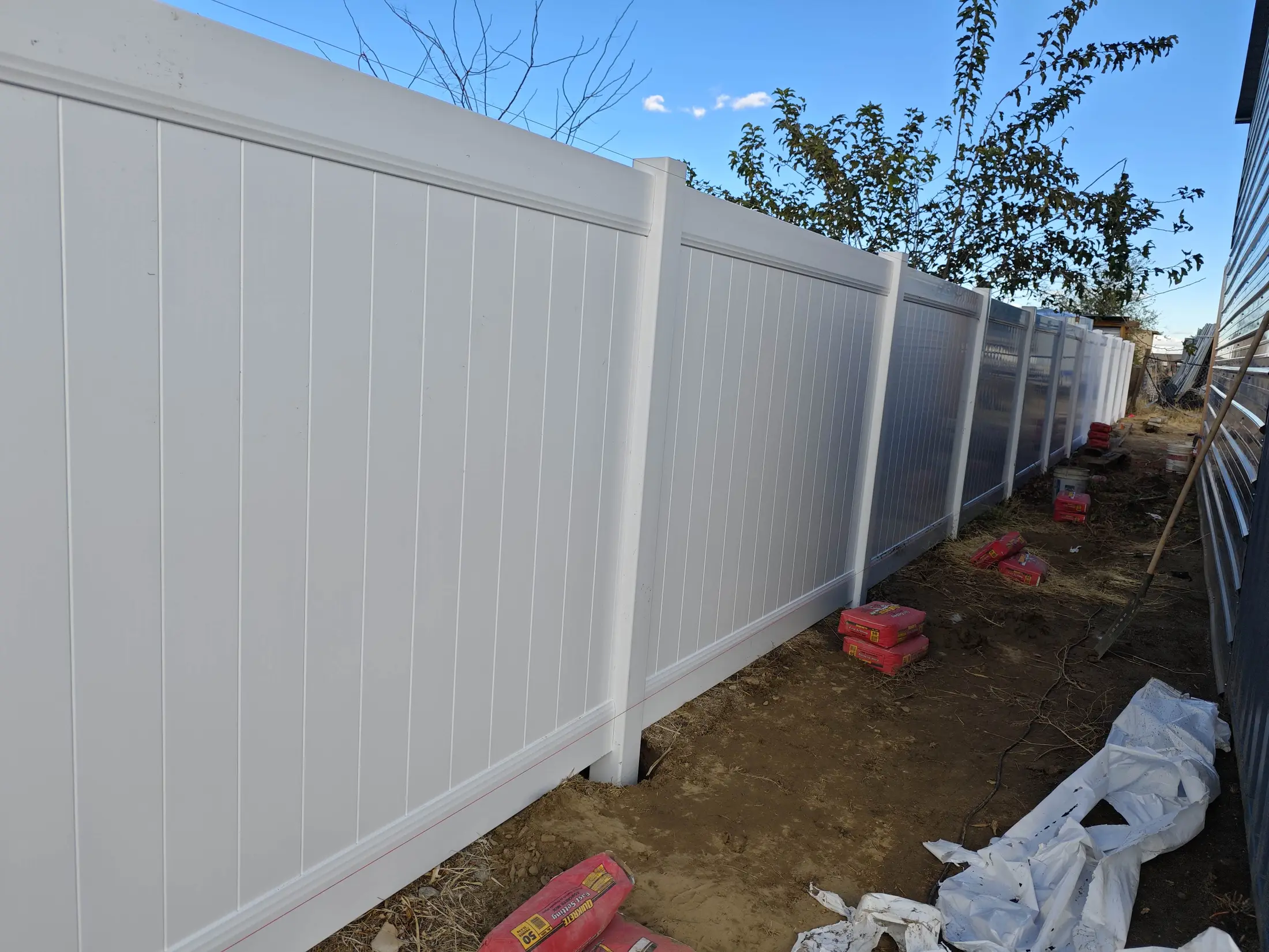 Finish detail on a white vinyl privacy fence