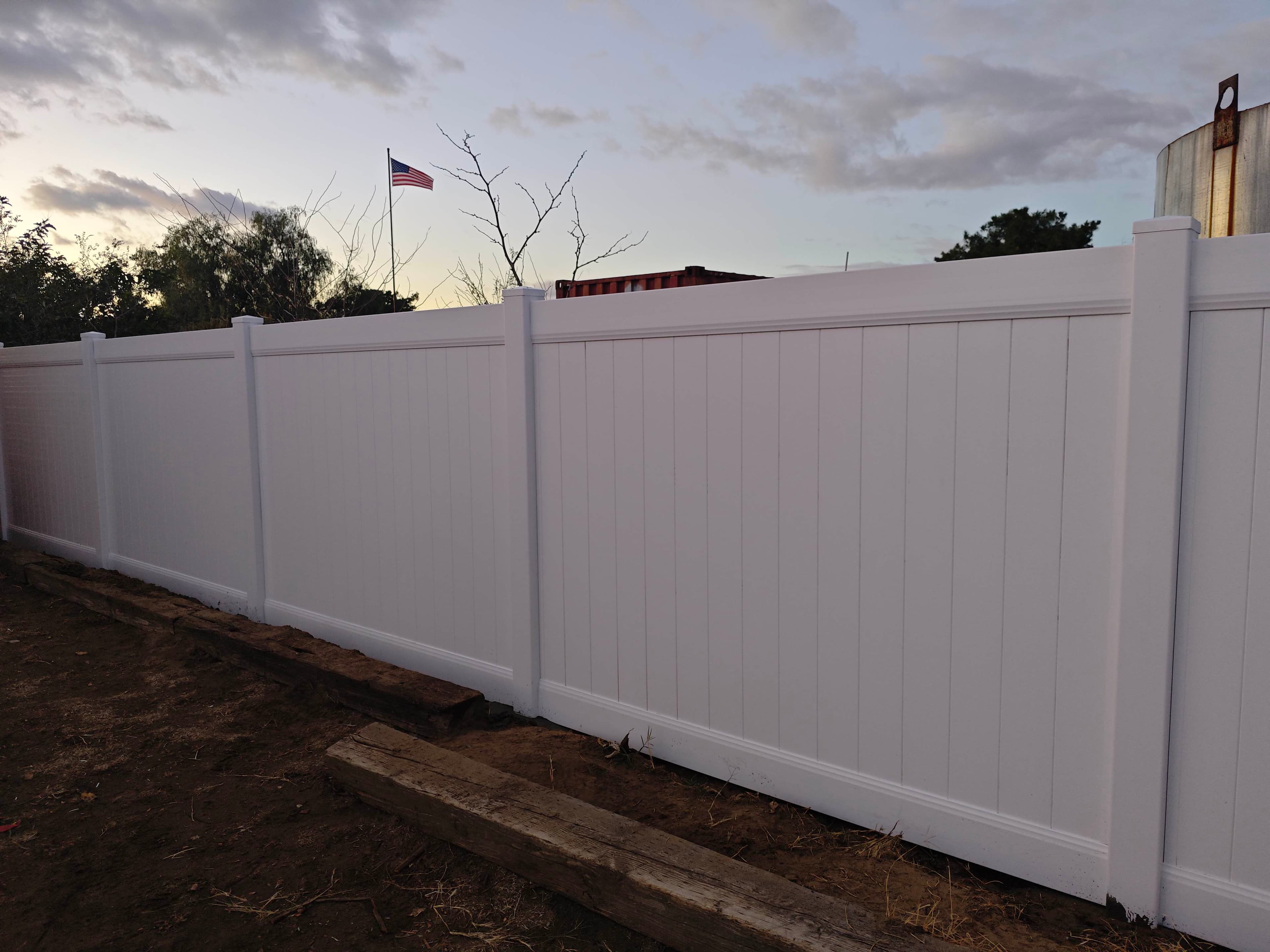 Gate area and panel alignment on a white vinyl fence