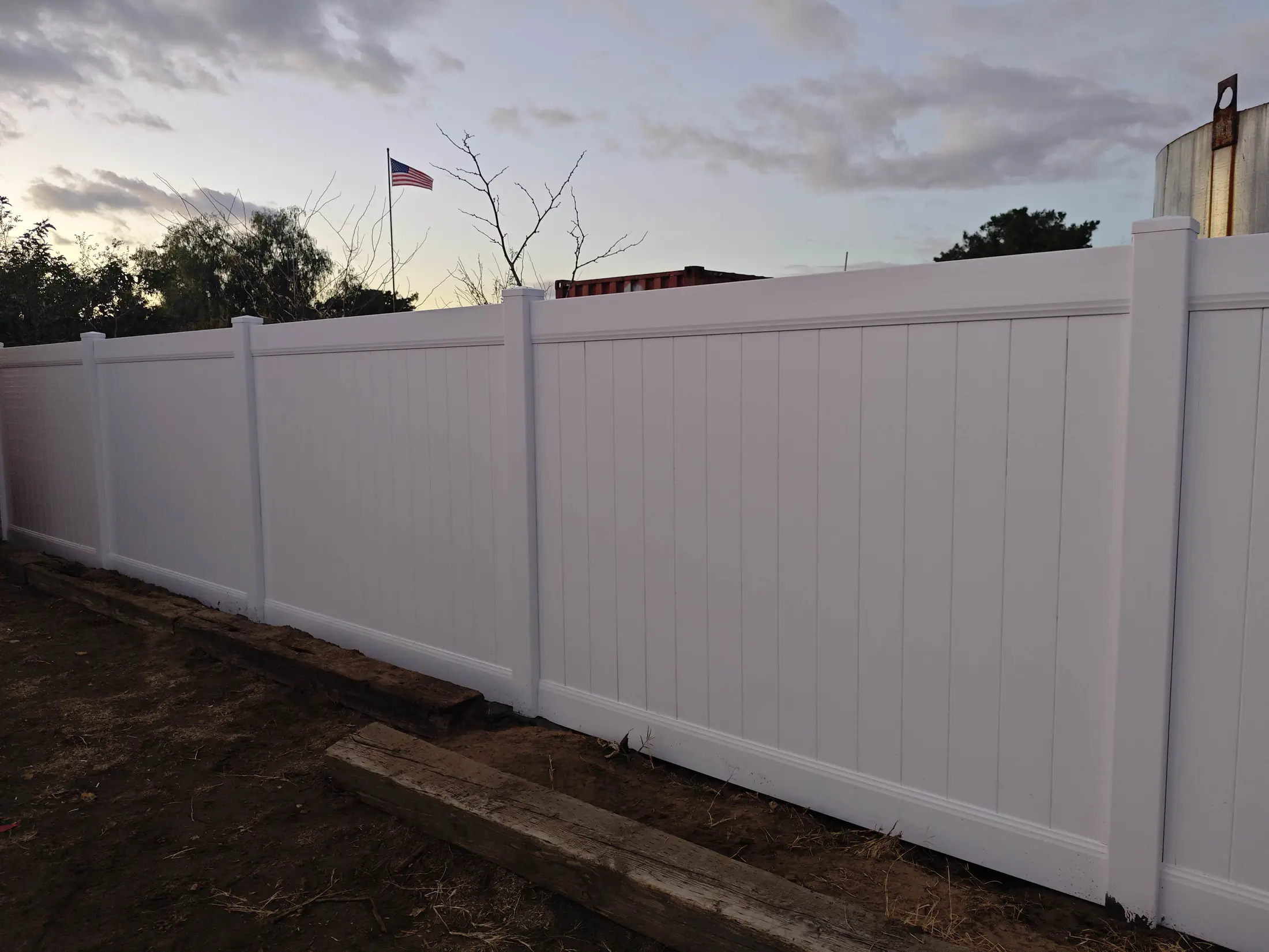 Gate area and panel alignment on a white vinyl fence