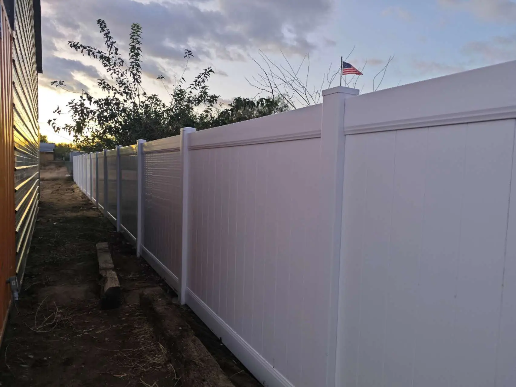 Overview of a completed white vinyl privacy fence