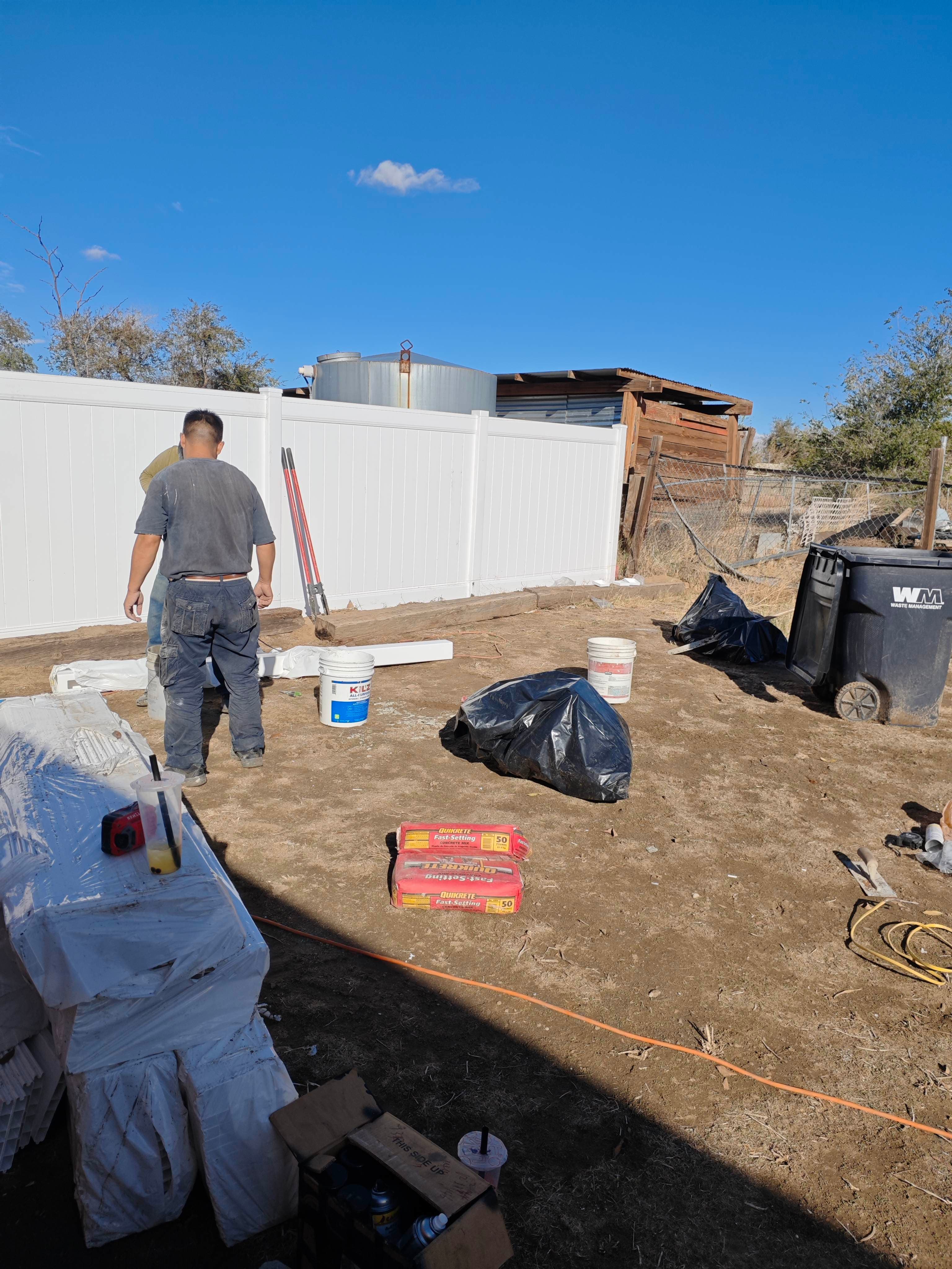 Post and panel detail on a white vinyl privacy fence