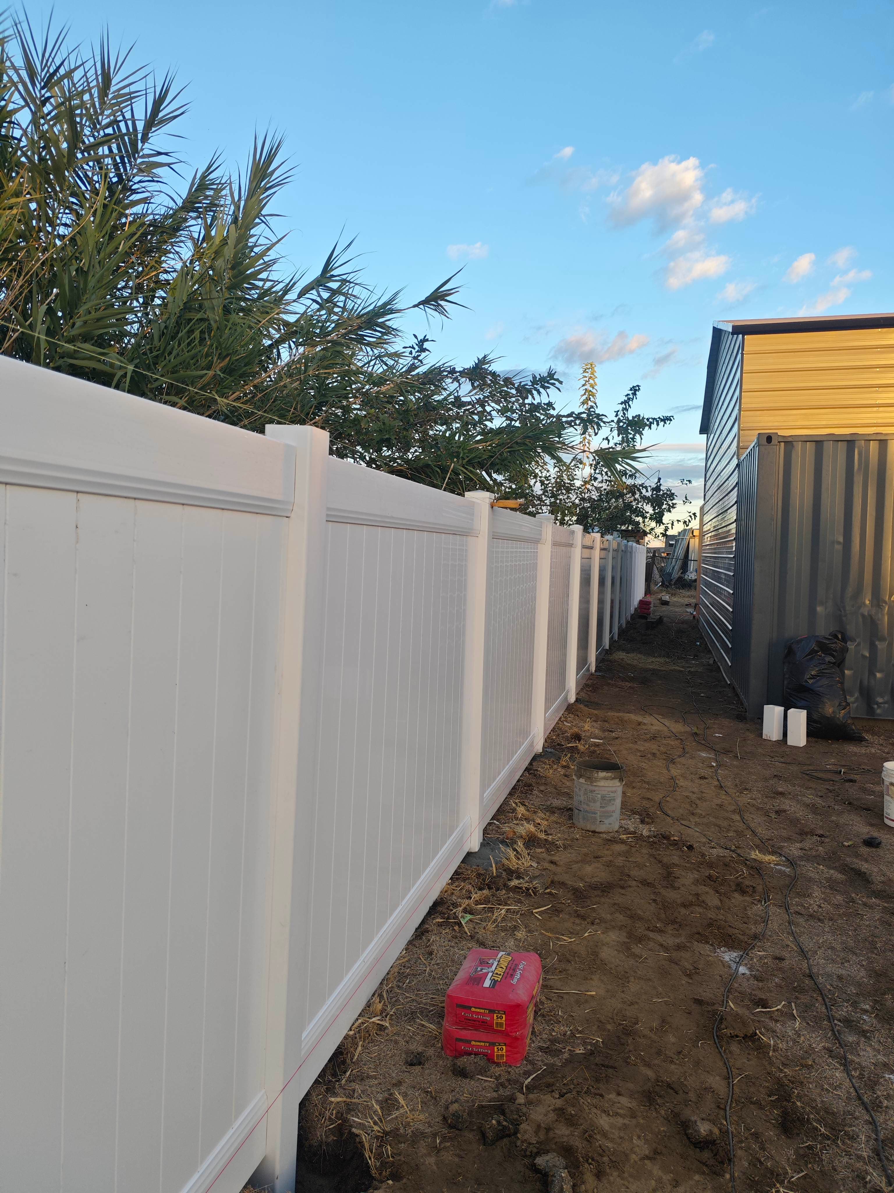 Vertical view of white vinyl privacy fence panels