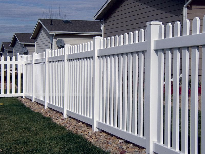 White vinyl picket fence along a front yard