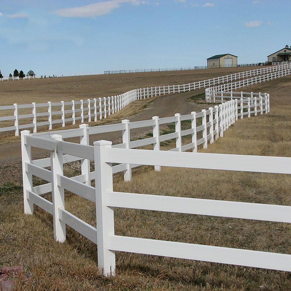 White vinyl ranch rail fence around open land